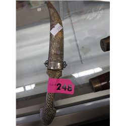 Brass knife in a metal sheath