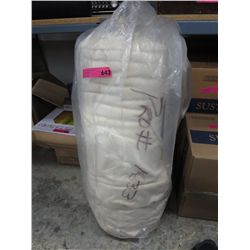 Roll of beige stretch fabric.