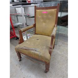 Antique carved arm chair, on casters