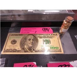 Gold foil banknote w/ vial of gold leaf