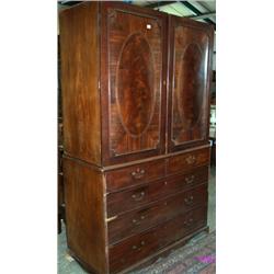 George III mahogany linen press with flame mahogany oval panels enclosing 5...