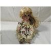 Image 1 : SMALL SEATED PORCELAIN DOLL IN FLORAL DRESS