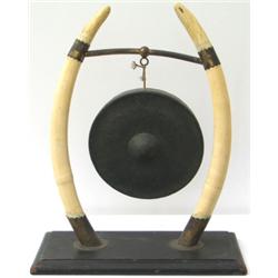Late C19th / early C20th bronze dinner gong supported by a pair of ivory...