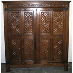 Early C20th carved oak 2-door cupboard with vine frieze & linenfold ends,...