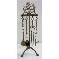Set of bronze handled fire tools on ornate stand