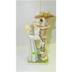 porcelain figurine girl with child looking at doves, by