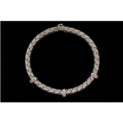 BRACELET:  [1] 18KWG flex bangle bracelet by Roberto Coin with a blue sapphire clasp and set with 48