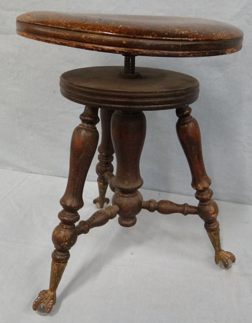Oak piano stool, brass claw, glass ball feet
