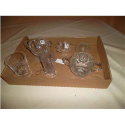 Collection of cut glass. 1 cream & sugar set; 1 water glass; 2 votive holders; 1 vase