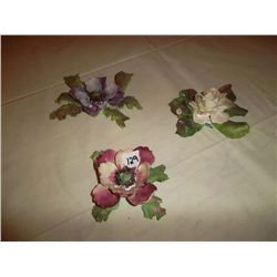 Porcelain flowers - 1 white with some damage; 1 red with a leaf missing; 1 purple in pristine condit