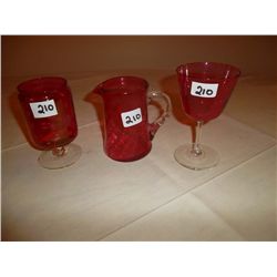 Collection of cranberry glass. 1 wine glass; 1 goblet and 1 small pitcher