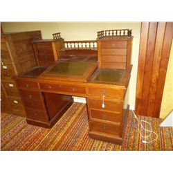 Large oak desk with leather inserts on writing surface