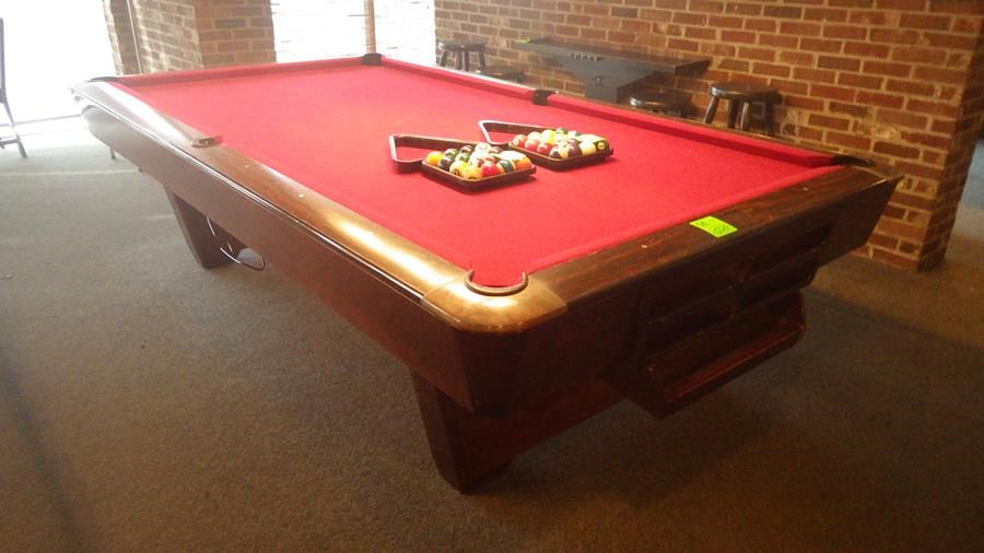 Brunswick medalist professional 4 1/2 x 9 ft slate regulation 8 ball/9 ball table with ball return.