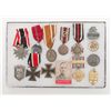 Image 2 : Lot in riker mount of German iron crosses and  service medals from WW I and WW II.  Est.:   $250-$50