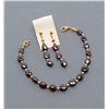 Jewelry lot consisting of a ladies 8” bracelet of  semi-precious garnets with gold plated findings