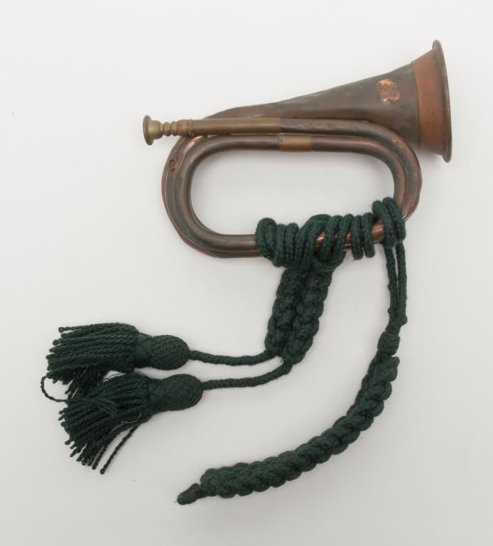 String Handle On Bugle Old copper bugle with green woven cord and tassels. Est.: $50-$75.