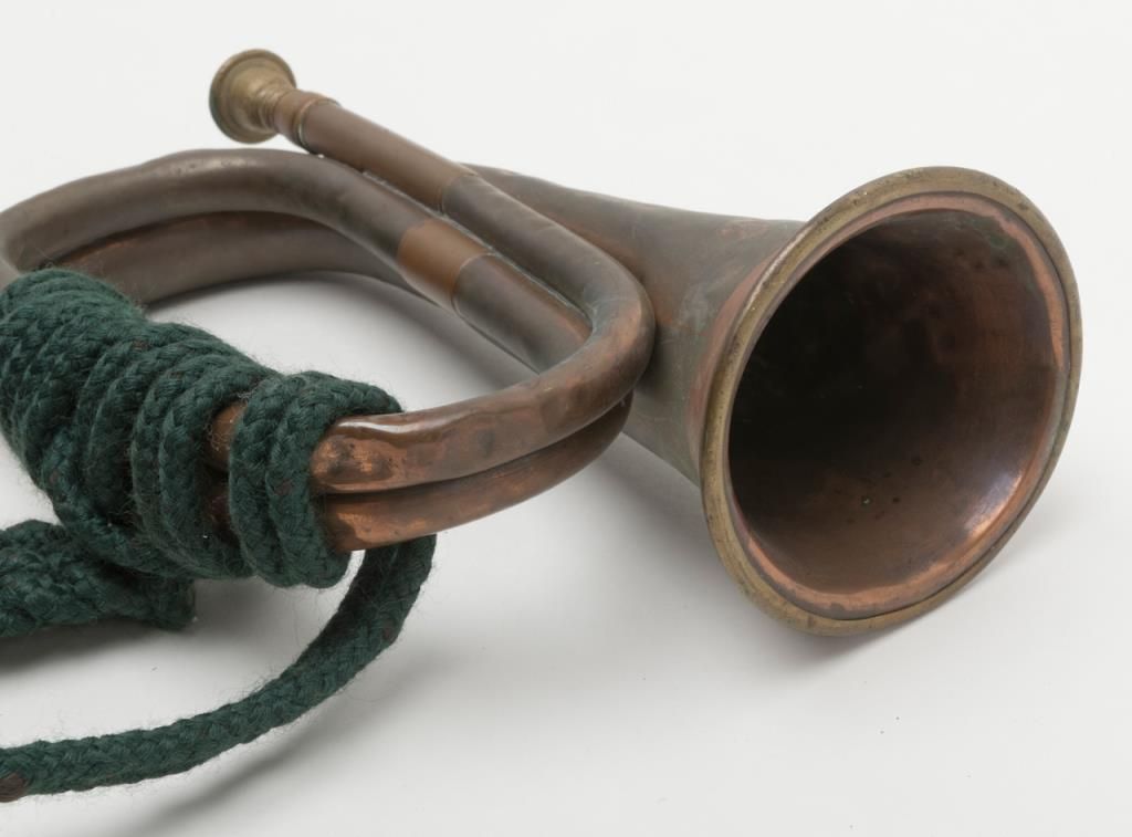 String Handle On Bugle Old copper bugle with green woven cord and tassels. Est.: $50-$75.