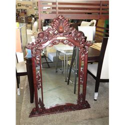 Wall mirror with ornate carved frame