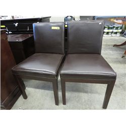 NEW - 2 leather dining chairs.