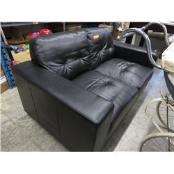 Black bonded leather love seat.
