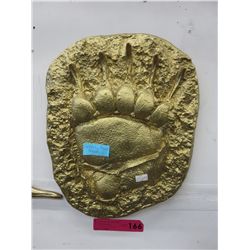 Gold painted plaster mold of a grizzly bear track