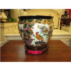 Glazed ceramic plant pot on stand