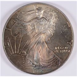 1995 AMERICAN SILVER EAGLE, MONSTER RAINBOW TONING ON THE OBVERSE