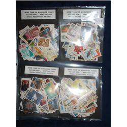 FOUR PACKAGES OF STAMPS - more than 100 in each