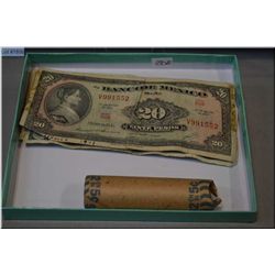 Canadian two dollar bill, one dollar bill, twenty dollar bill and a roll of nickels