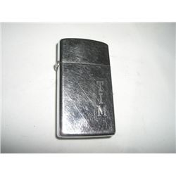 VINTAGE *ZIPPO* LIGHTER STAMPED *TIM* WITH PATTERN ON LIGHTER!! LIGHTER CAME OUT OF SAFE!!