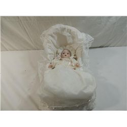 SMALL PORCELAIN BABY DOLL IN WICKER CRADLE