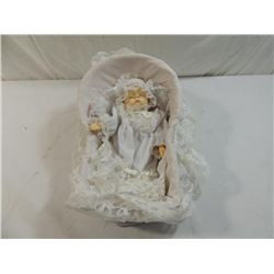 SMALL PORCELAIN MUSIC BOX BABY DOLL IN WICKER CRAD