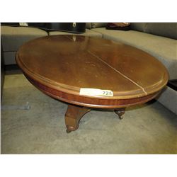 Oval wood coffee table on casters
