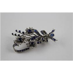 ONE 18KT WHITE GOLD NATURAL BLUE SAPPHIRE AND DIAMOND SET BROOCH. HAND ASSEMBLED, VINTAGE FLORAL