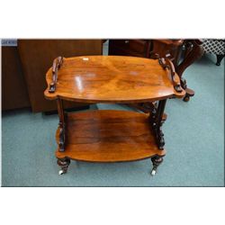 Victorian two tier parlour table with decorative finials, curved supports and original brass castors