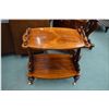Image 1 : Victorian two tier parlour table with decorative finials, curved supports and original brass castors