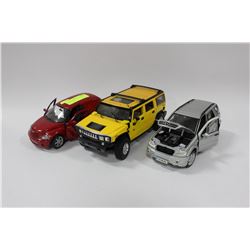 FLAT OF THREE 1:18TH SCALE DIE CAST CARS
