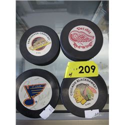 4 Hockey pucks - 1 signed by Brett Hull