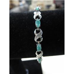 Emerald & Diamond cross over tennis bracelet