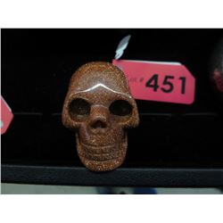 Carved goldstone skull