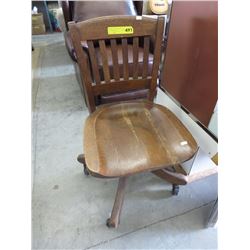 Vintage oak office chair on casters