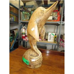 Carved wood dolphin statue