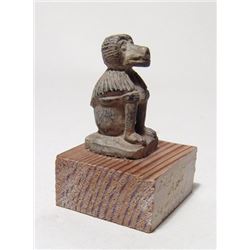 An Egyptian steatite amulet of a seated baboon