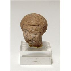 An Egyptian head of a man wearing a wig