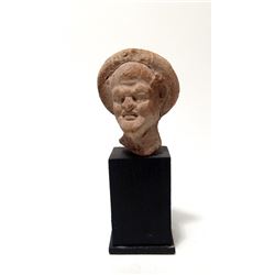 An Egyptian terracotta head of a man