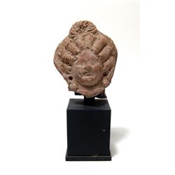 An Egyptian terracotta head of a woman