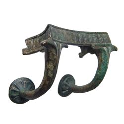 An ornate Greek bronze handle from a large vessel