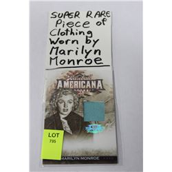 PIECE OF CLOTHING IN CARD  WORN BY MARILYN MONROE