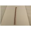 Image 1 : ONE 10KT YELLOW GOLD AND RHODIUM FINISH RUBY AND DIAMOND SET BRACELET. SET WITH A TOTAL OF 22 OVAL