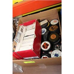 BOX W/ VARIOUS HOCKEY PUCKS AND CARDS